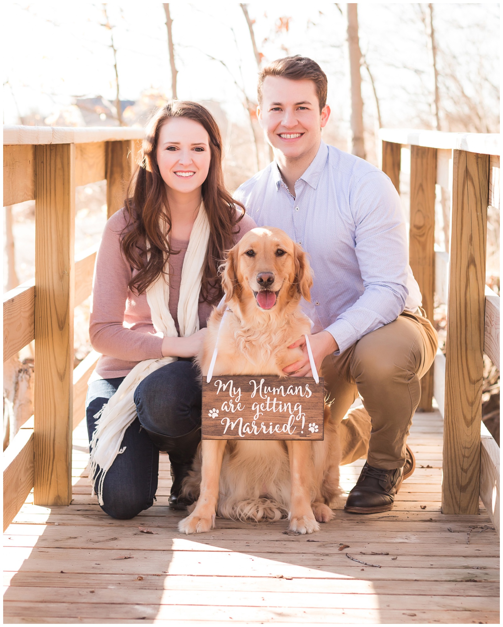 Golden retriever on bridge with feet of bride and groom to be