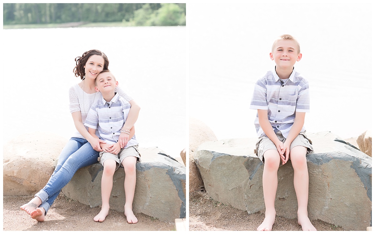 mother and son sitting on large rock along beach