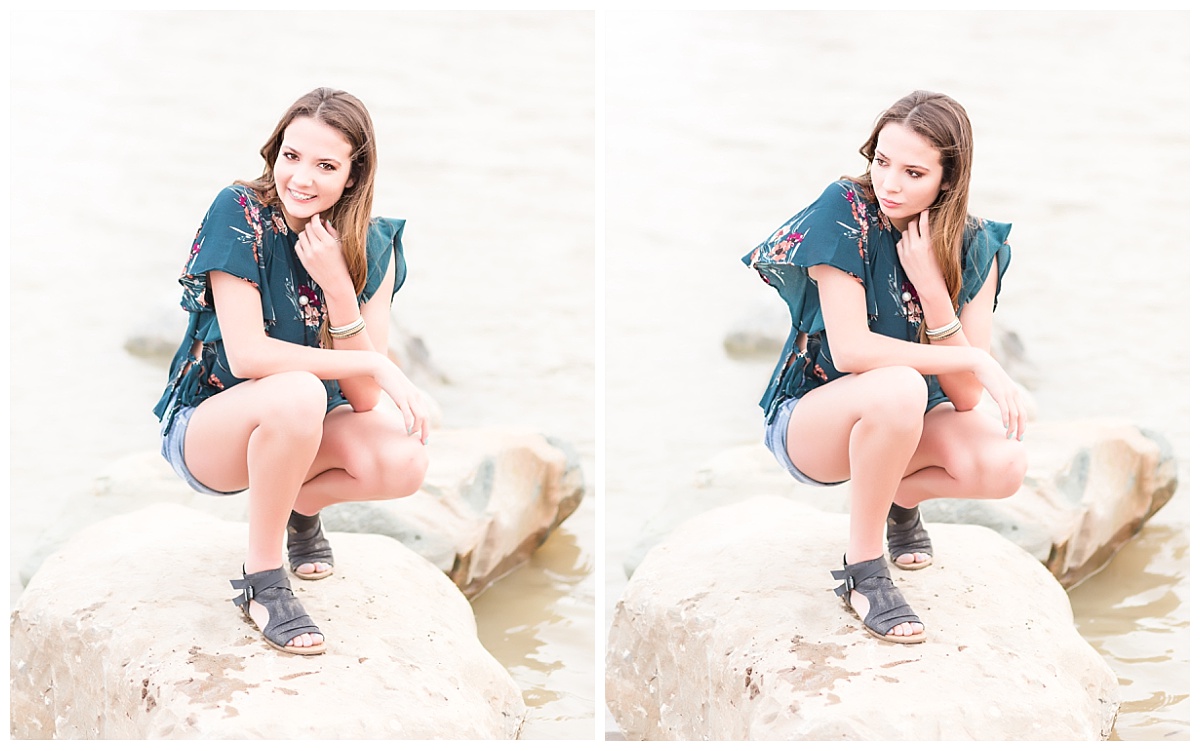 senior girl kneeling on rocks at beach