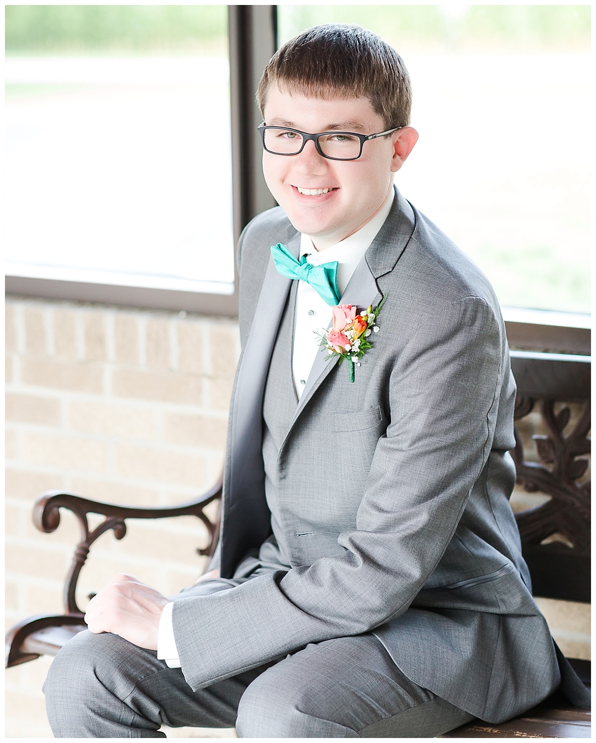 groom sitting | teal bow-tie and coral boutonniere 