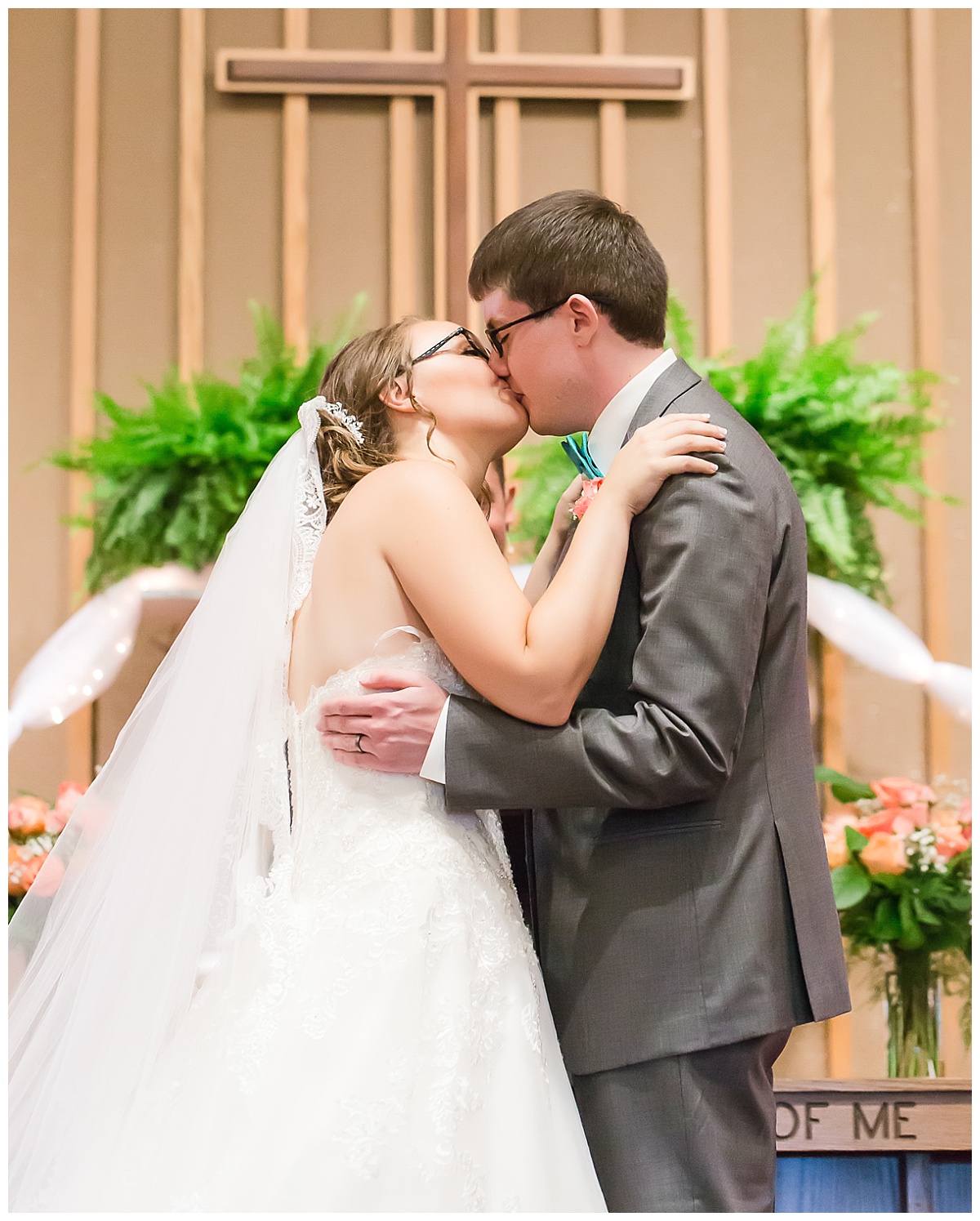 bride and groom kissing at alter