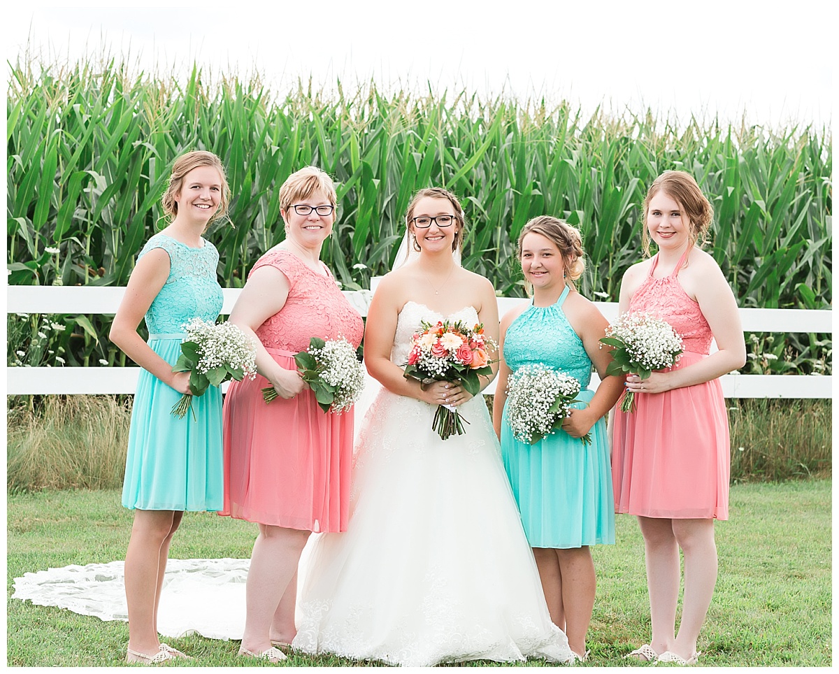 bride with bridesmaids | teal and coral dresses baby's breath bouquets
