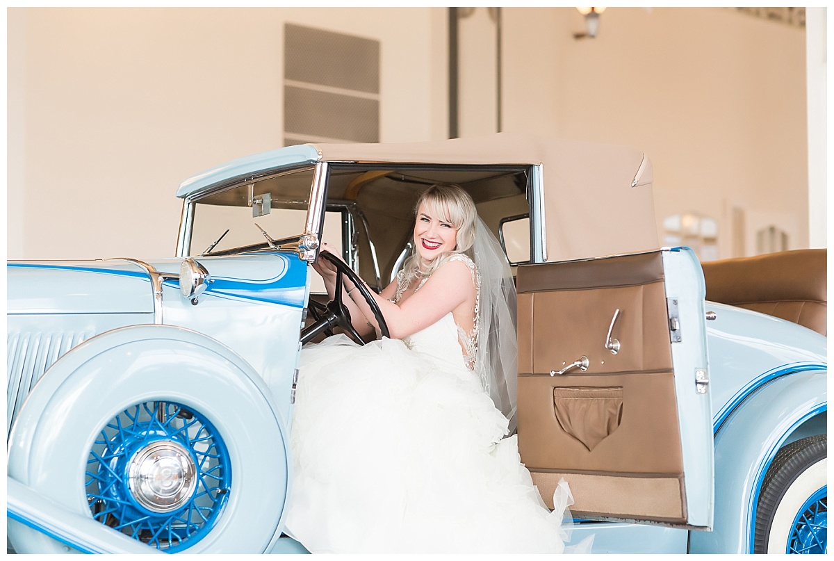 Bride in vintage automobile at Auburn Cord Duesenberg Museum wedding photo by Simply Seeking Photography